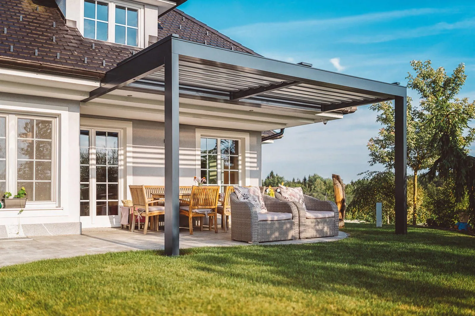 Timber pergola beside aluminum doors on a patio