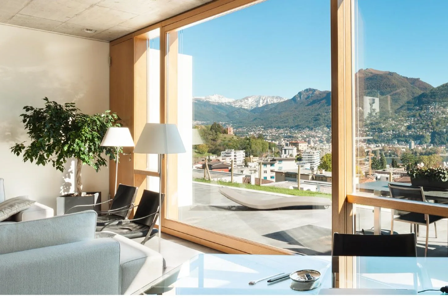 Panoramic interior view through a wide wood-clad lift and slide door
