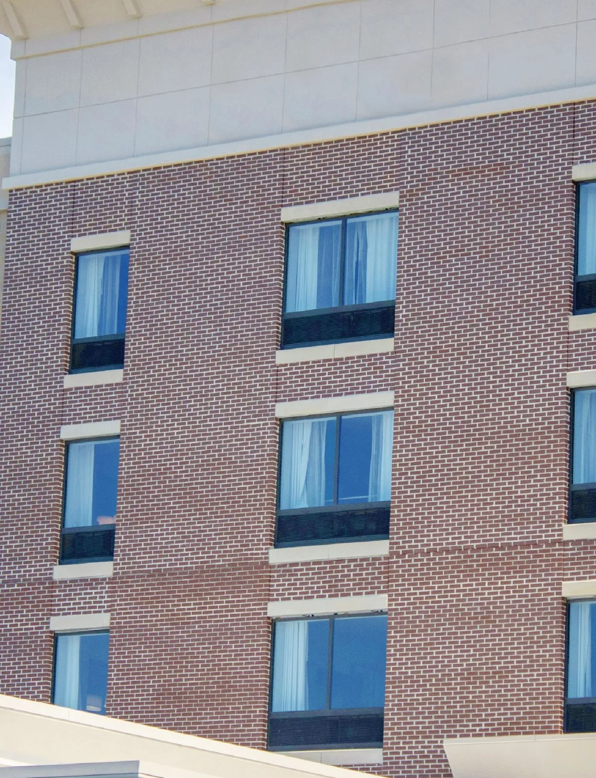 PTAC windows on a brick hotel building